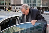 George Pell gets into a car outside court.