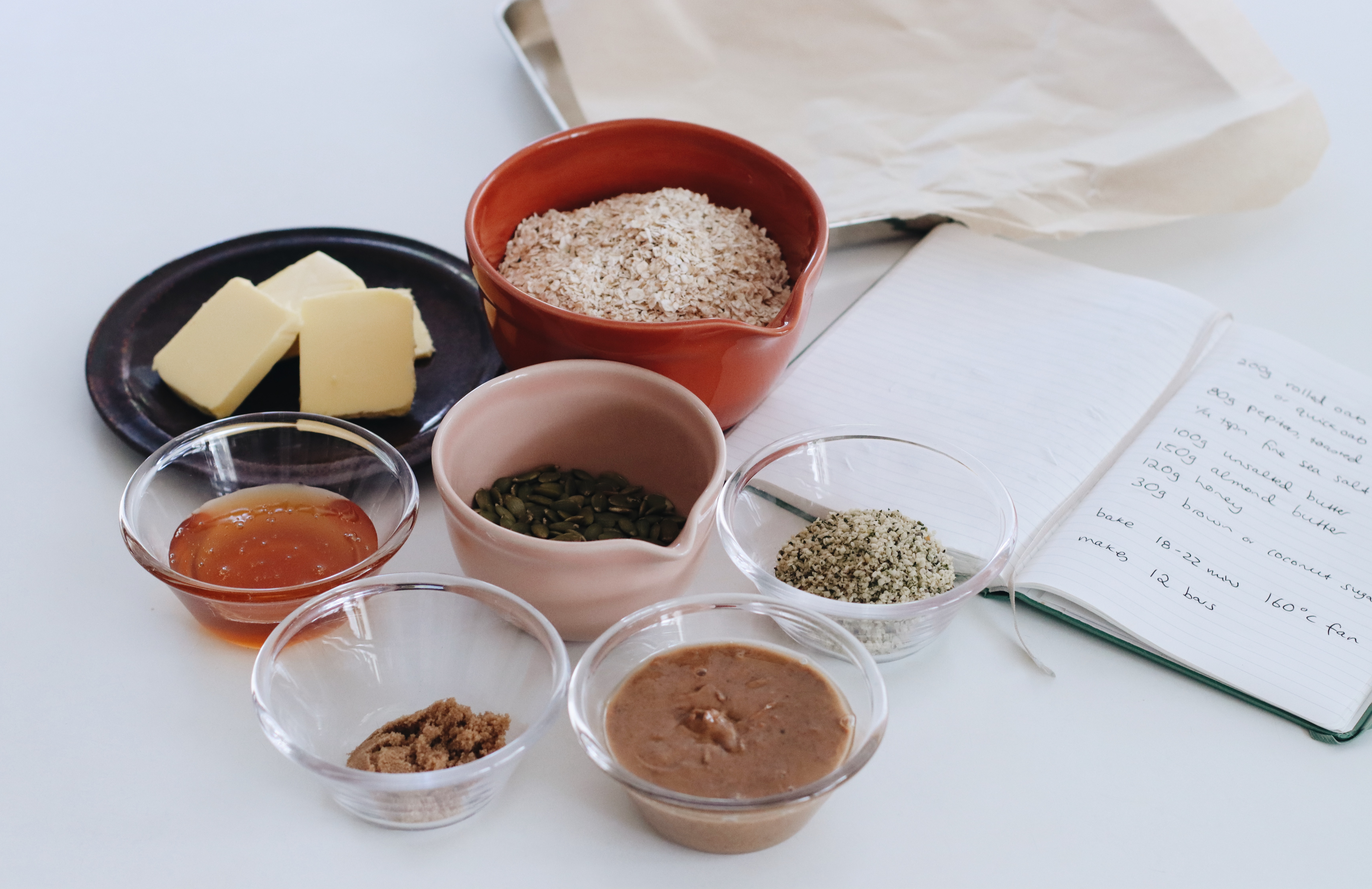 Small bowls of ingredients lined up on a bench.