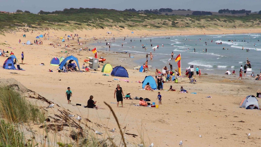 people flock to a beach in warrnambool in southwest victoria 