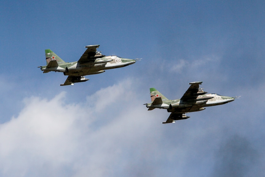 Russian Sukhoi Su-25 jet fighters fly in formation during military drills