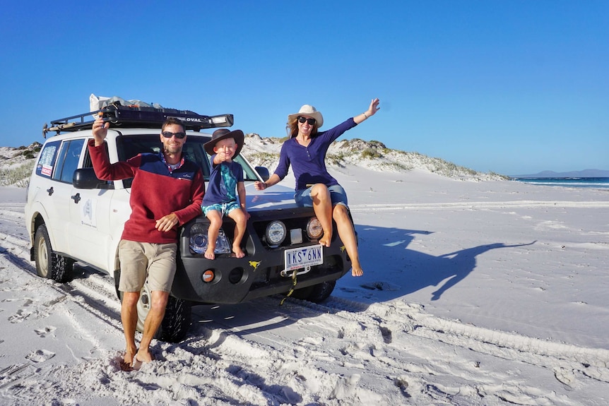 Renee, Nathan and Ryan pose on their 4WD during their travels