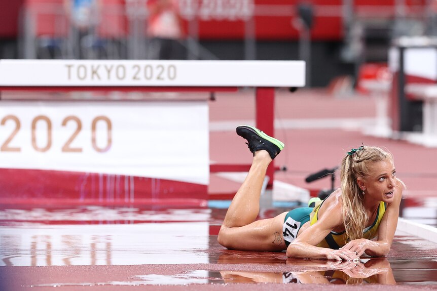 Genevieve Gregson lies on the ground of the track