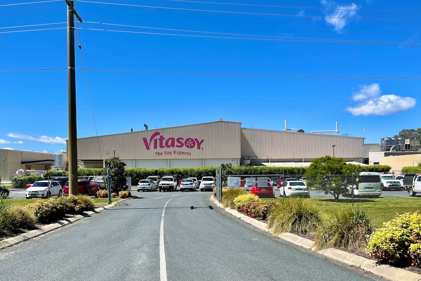 A large building with 'Vitasoy' sign on the roof.