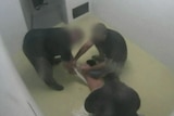 Dylan Voller being stripped by prison guards.