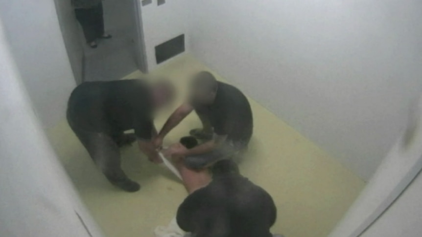 Dylan Voller being stripped by prison guards.