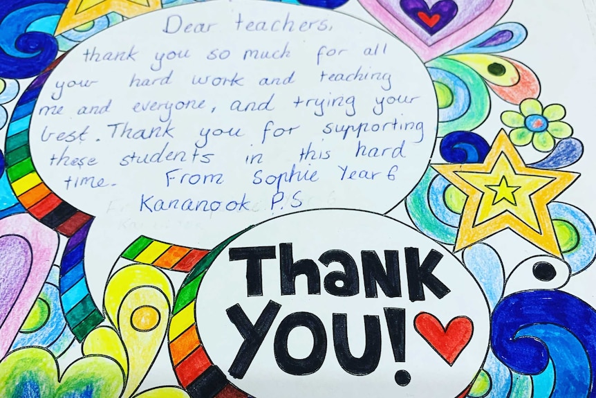 A colourful card with printed stars, flower and hearts written on by a child thanking teachers.