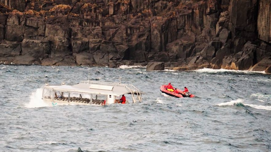 A boat from the Coral Discoverer and rescue dinghy in heavy seas off Cape Raoul.