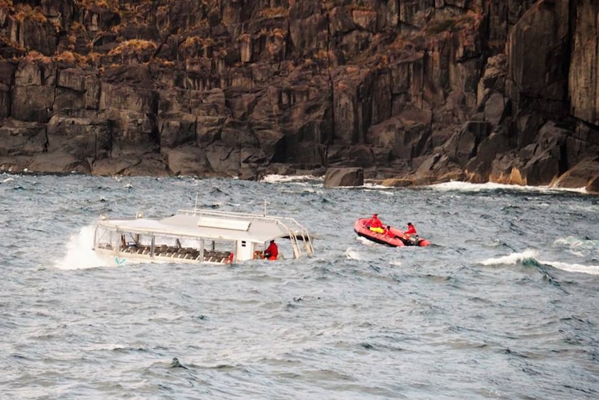 A boat from the Coral Discoverer and rescue dinghy in heavy seas off Cape Raoul.