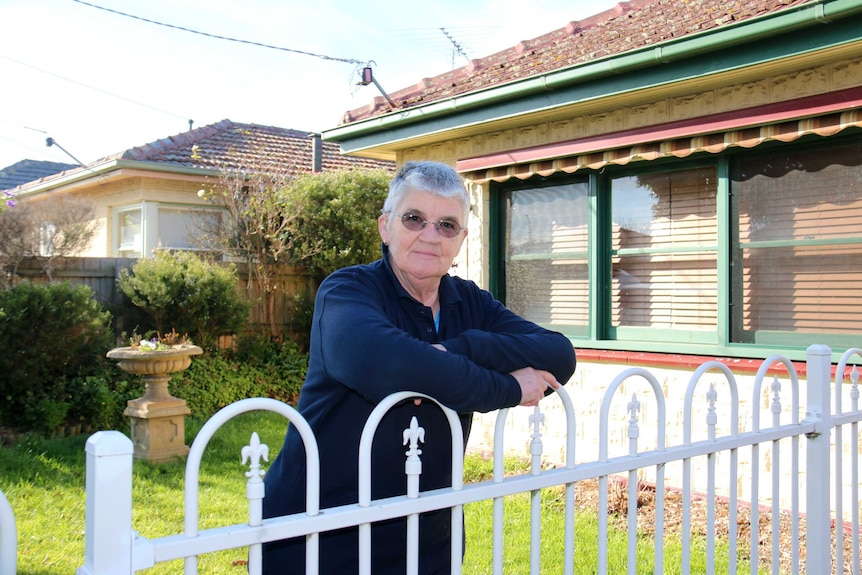 Pat Mitchell stands outside her home in Belmont.