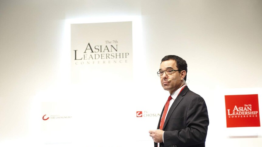 Entrepreneur Tony Seba stands in front of a white wall.