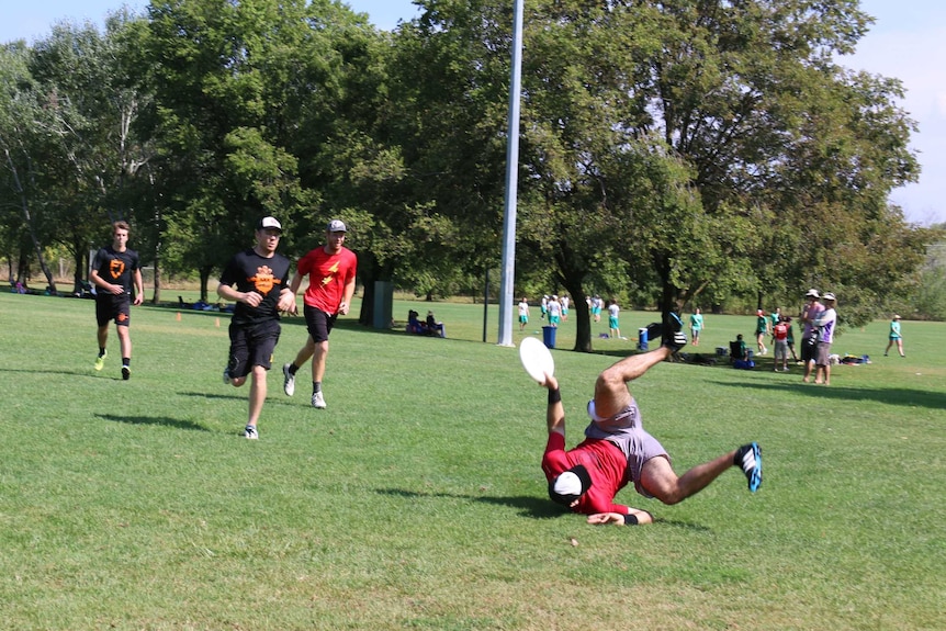 Ultimate Frisbee player takes a dive