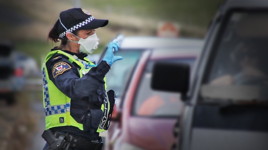 Female Tasmania Police officer wearing face mask at traffic stop