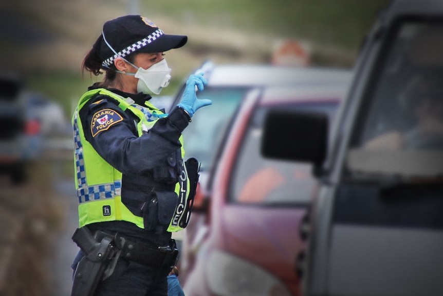 Female Tasmania Police officer wearing face mask at traffic stop
