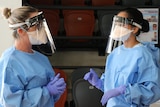 Two health staff in PPE at the Marrara COVID testing facility.
