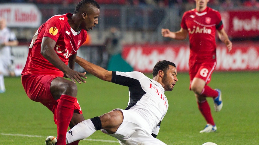 Twente's Douglas (L) fights for the ball with Fulham's Moussa Dembele.