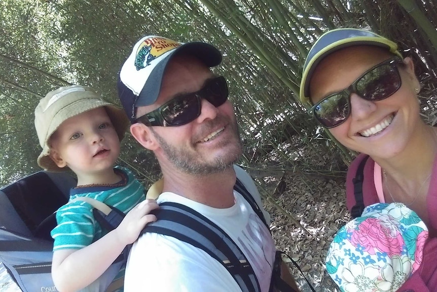 A photo of toddler Sonny hiking with his parents