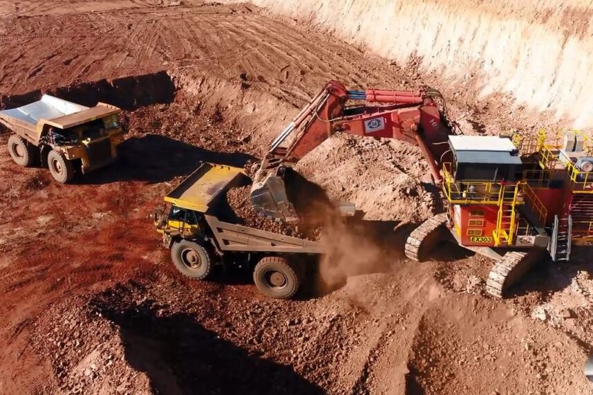 Trucks dig at a manganese mine