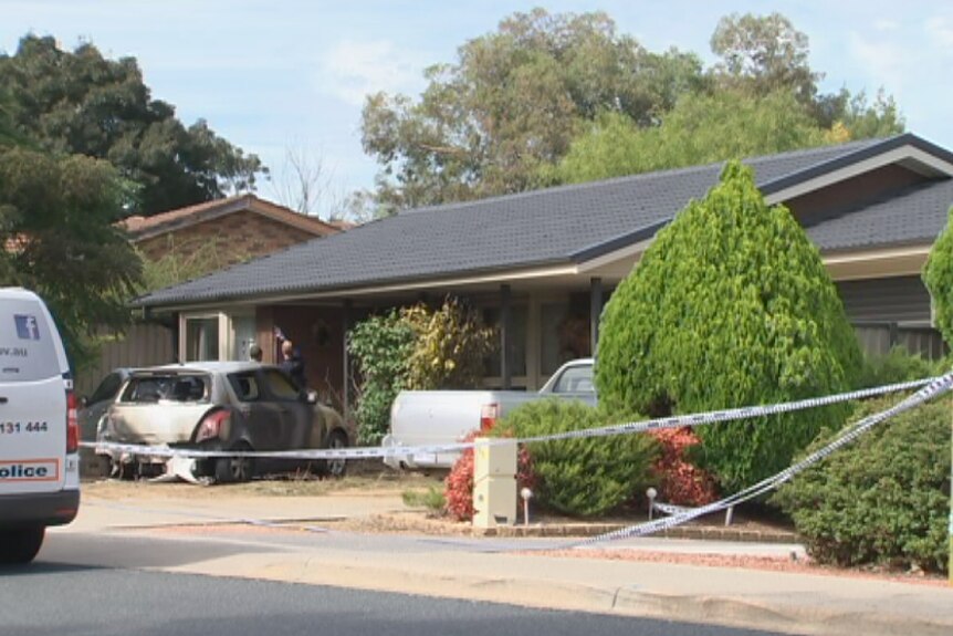 Police tape blocks access to a home in south Canberra that was targeted by bikie gangs.
