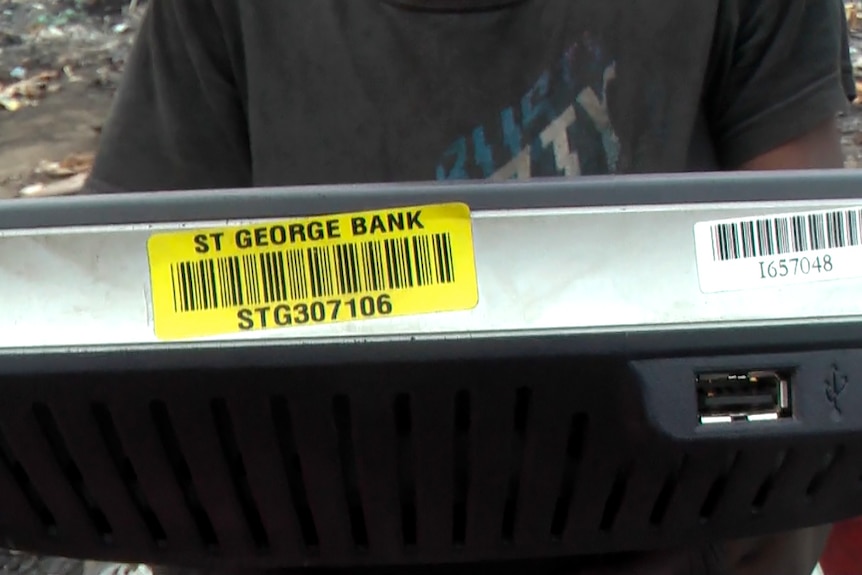 A boy holds e-waste from St George Bank at Agbogbloshie dump in Ghana's capital, Accra.