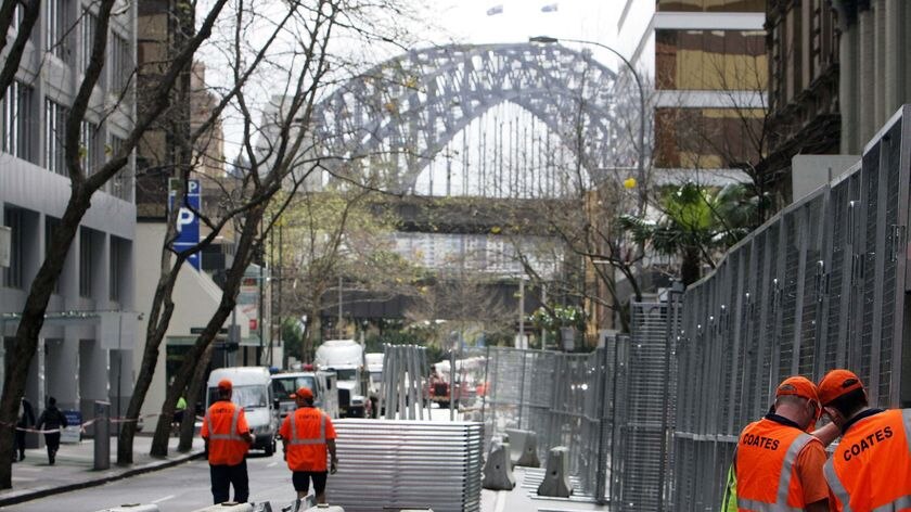 Security crackdown: Construction workers erect a fence around parts of the Sydney CBD