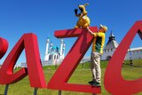 An Australia fan puts a kangaroo on the Kazan sign.