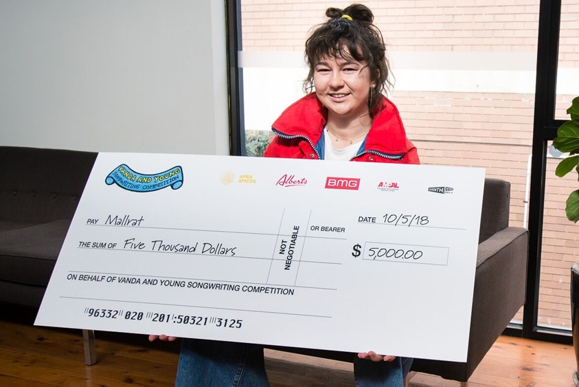 Mallrat with a $5,000 cheque for the 2018 Vanda and Young songwriting competition