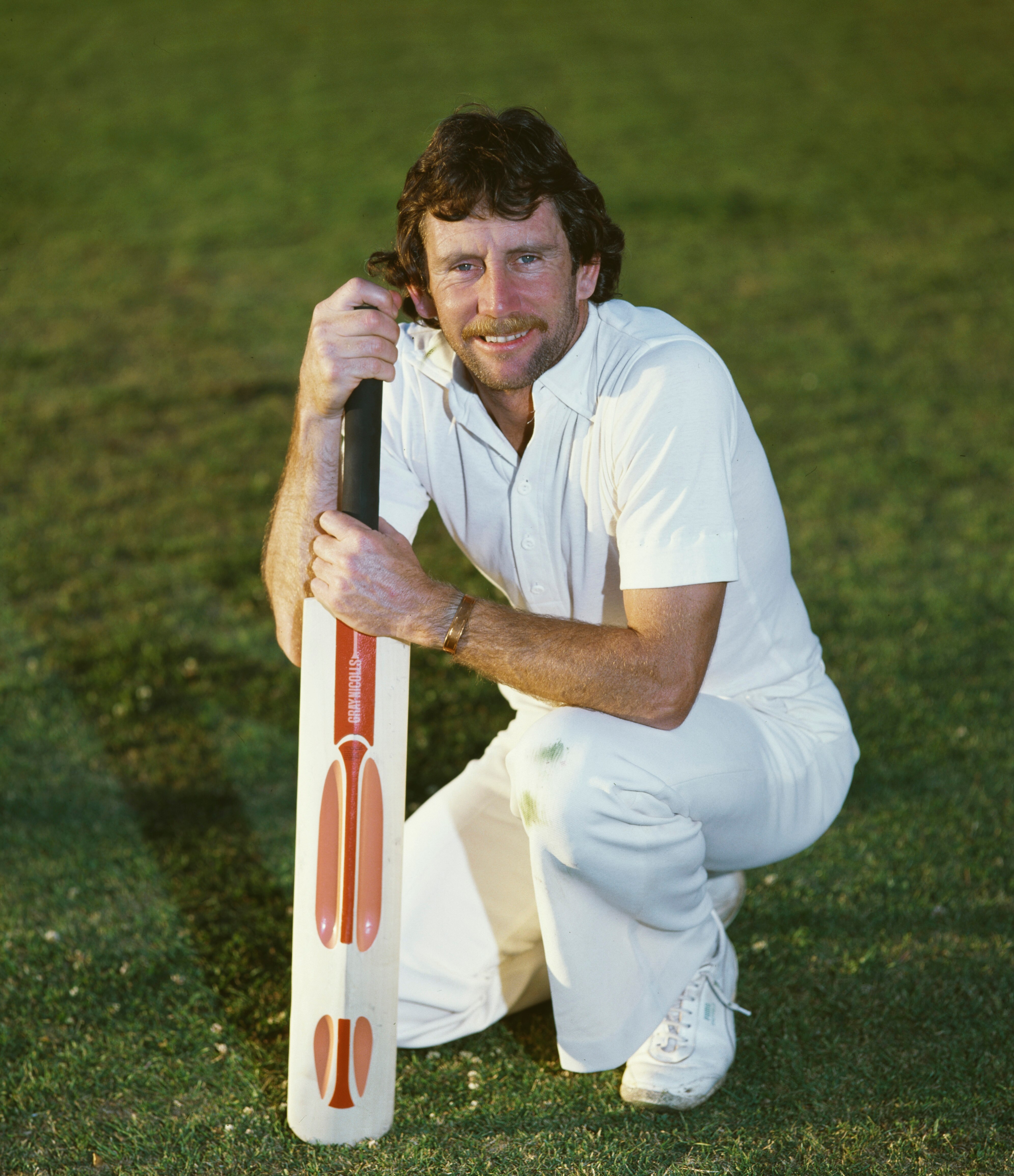 Ian Chappell in cricket whites pictured holding a cricket bat in 1980.