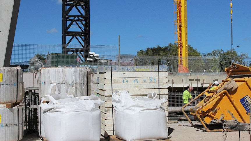 a construction site and crane and workers