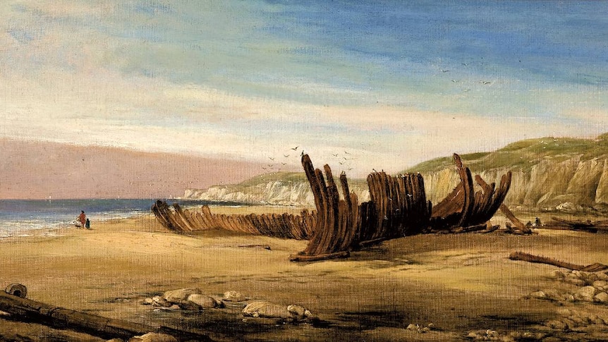 A painting of a shipwreck on a beach near limestone cliffs.