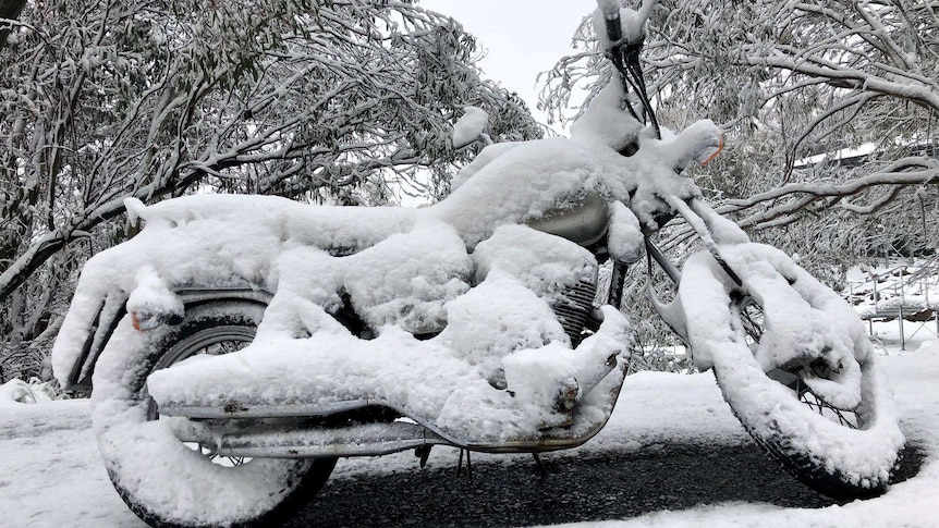 Motorbike covered in snow