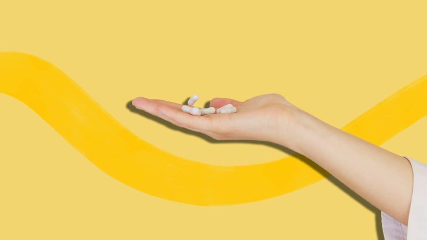 Person holding white capsules in front of a bright yellow background, for a story about whether collagen supplements work.
