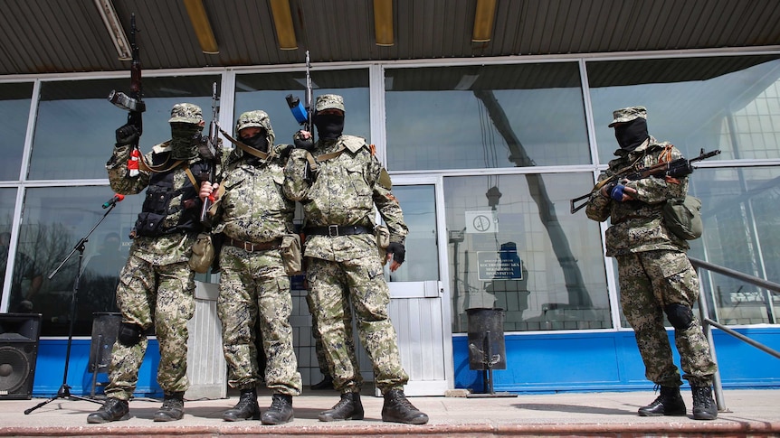 Pro-Russian armed men stand outside building in Kostyantynivka.