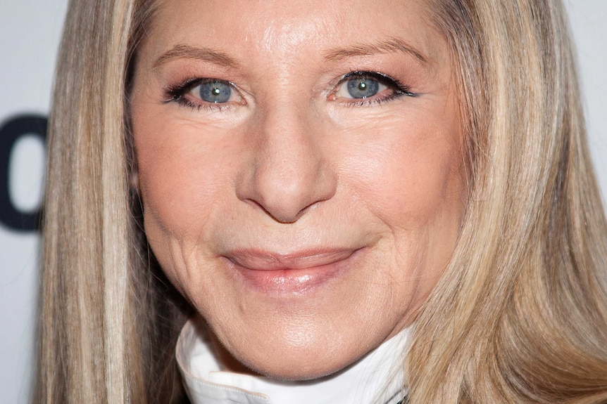 A close-up image of Barbra Streisand's face as she smiles.
