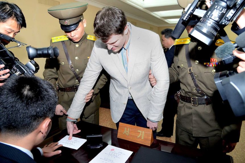 Man imprints thumb surrounded by cameras