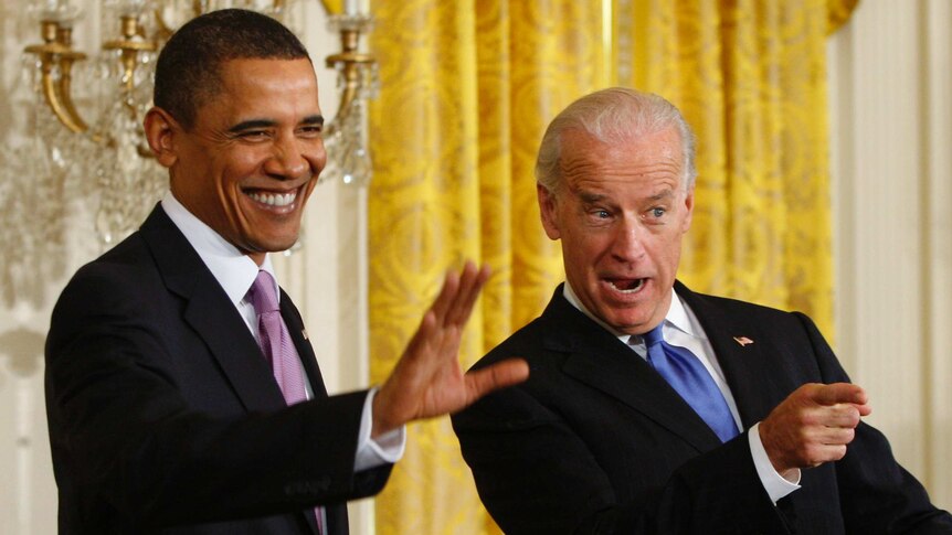 US President Barack Obama and Vice President Joe Biden wave to colleagues in the White House.