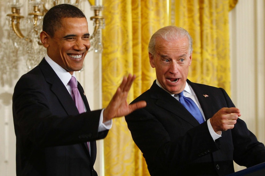 US President Barack Obama and Vice President Joe Biden wave to colleagues in the White House.