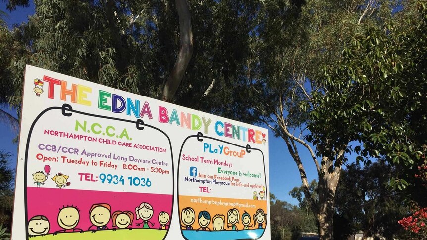 rainbow coloured sign titled The Edna Bandy Centre in front of eucalyptus tree