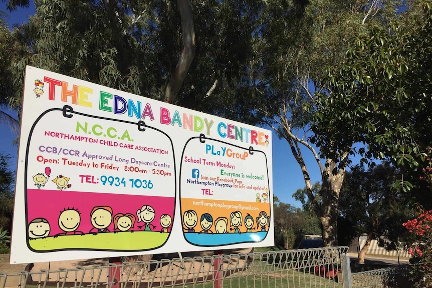 A rainbow coloured sign titled The Edna Bandy Centre in front of eucalyptus tree