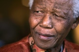 Nelson Mandela smiles as he formally announces his retirement.