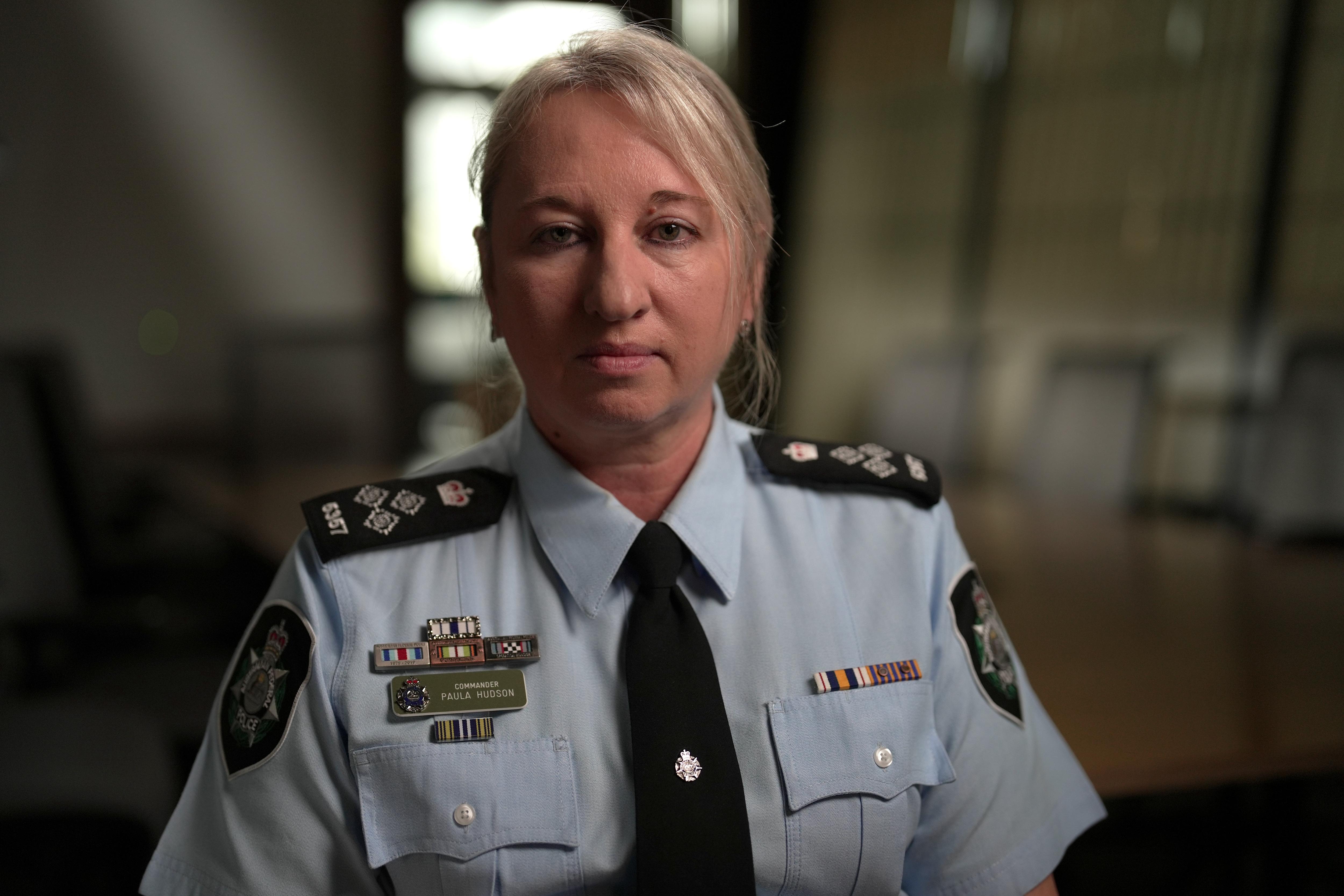 A woman wearing a police uniform.