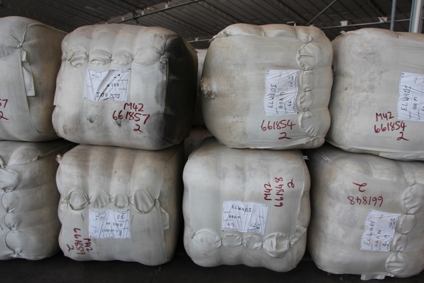 Stacked bales of wool inside a warehouse