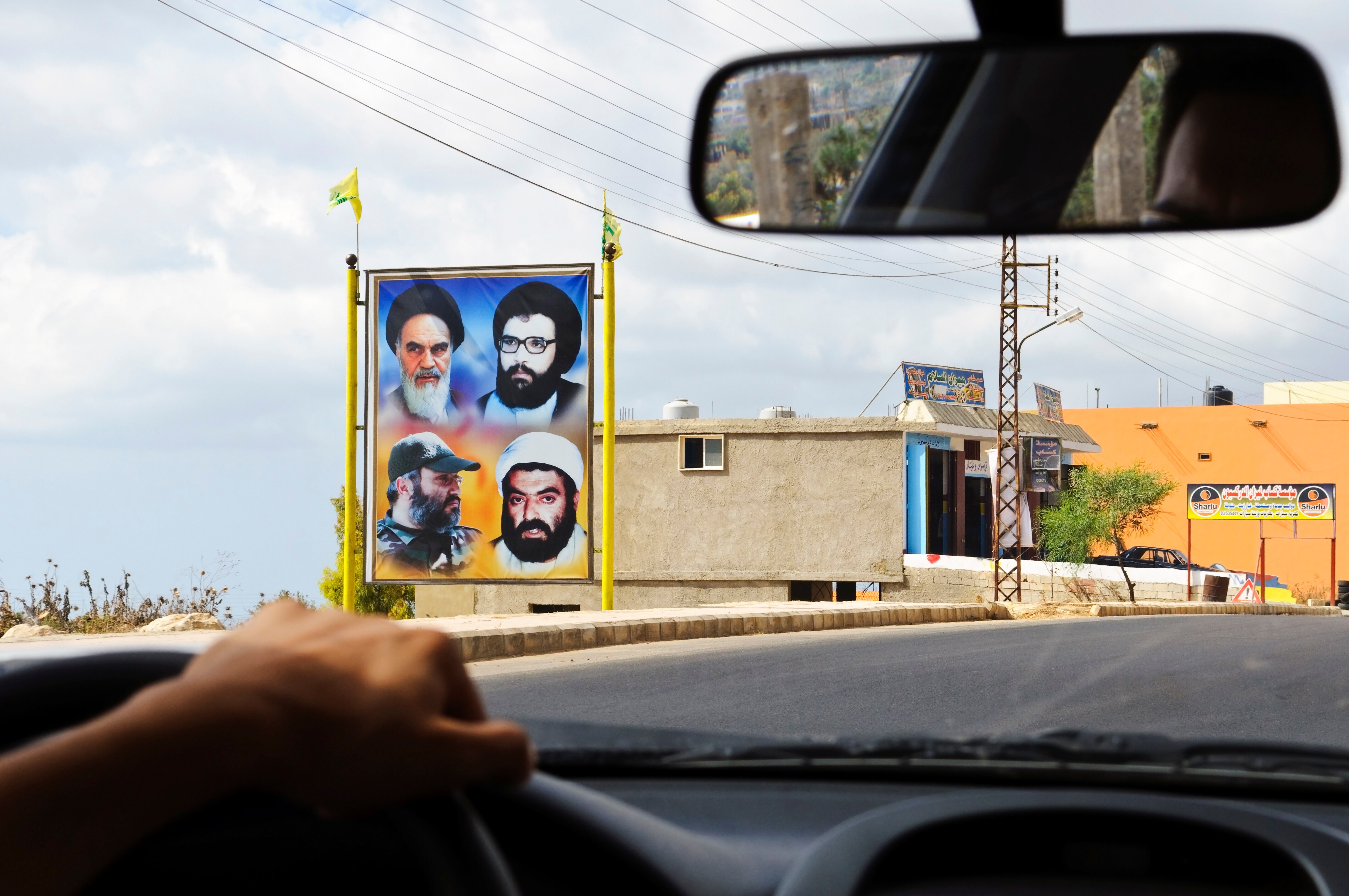 Image of four men on a roadside billboard.