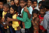 Children in Kathmandu lining up to receive food
