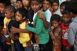 Children in Kathmandu lining up to receive food