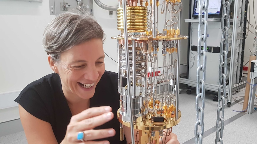 Michelle Simmons grins while gazing at complex lab equipment
