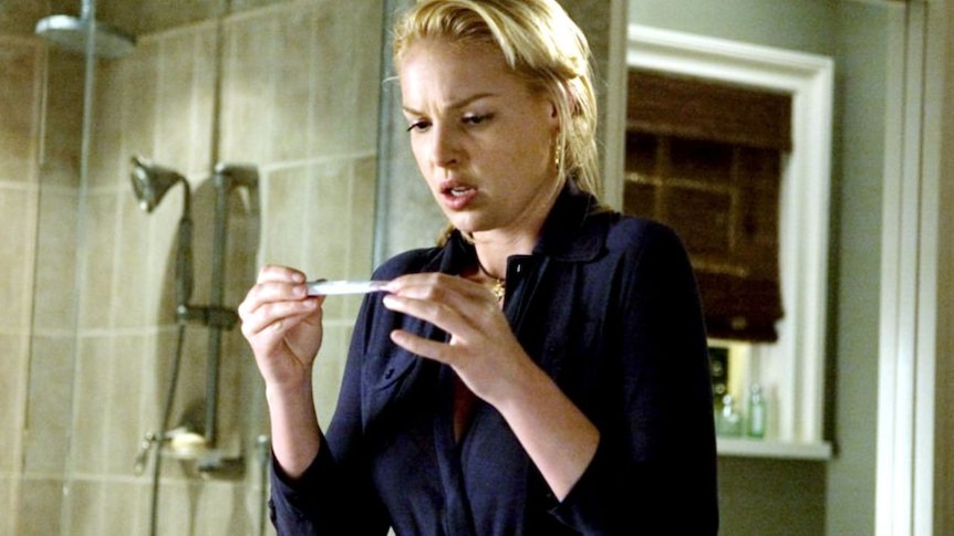 Katherine Heigl looks at a pregnancy test in shock in the 2007 film Knocked Up