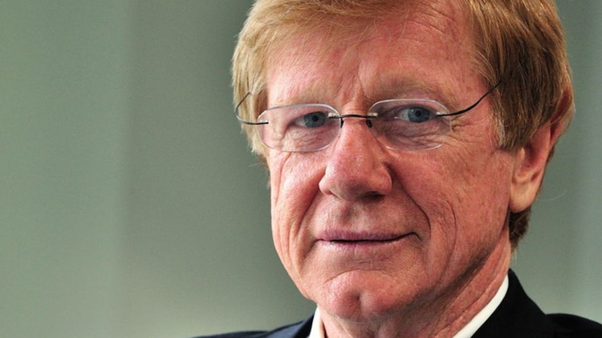 A close up picture of Retired Journalist, Kerry O'brien looking down the lens witha faded green background