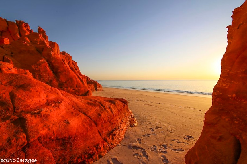 Red rocks at an isolated beach at sunset