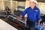 Katter's Australian Party MP Robbie Katter flips a sausage at a voting booth in Mount Isa.