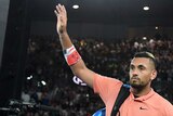 Nick Kyrgios waves as he leaves Rod Laver Arena after losing to
